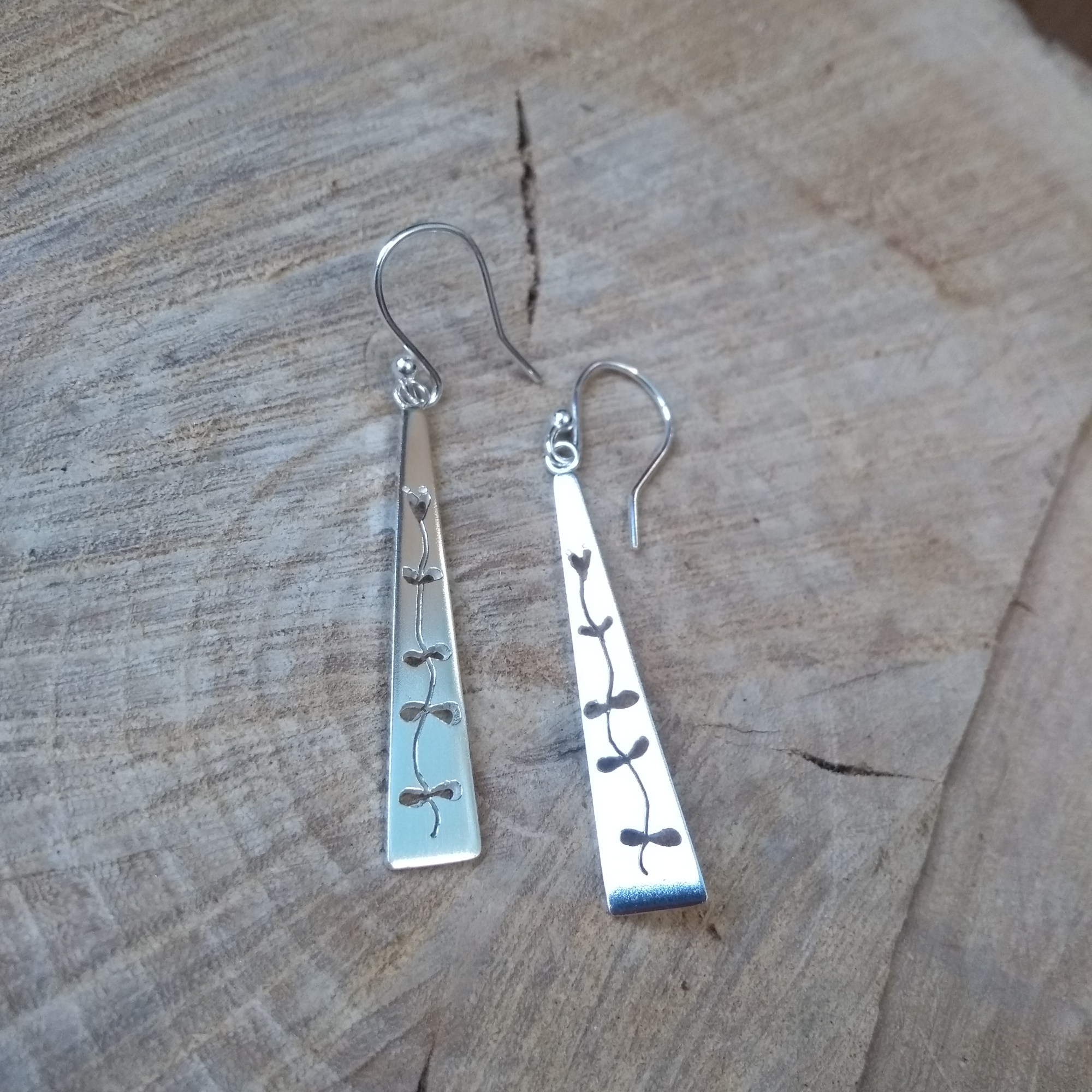 Pierced silver leaf dangle earrings