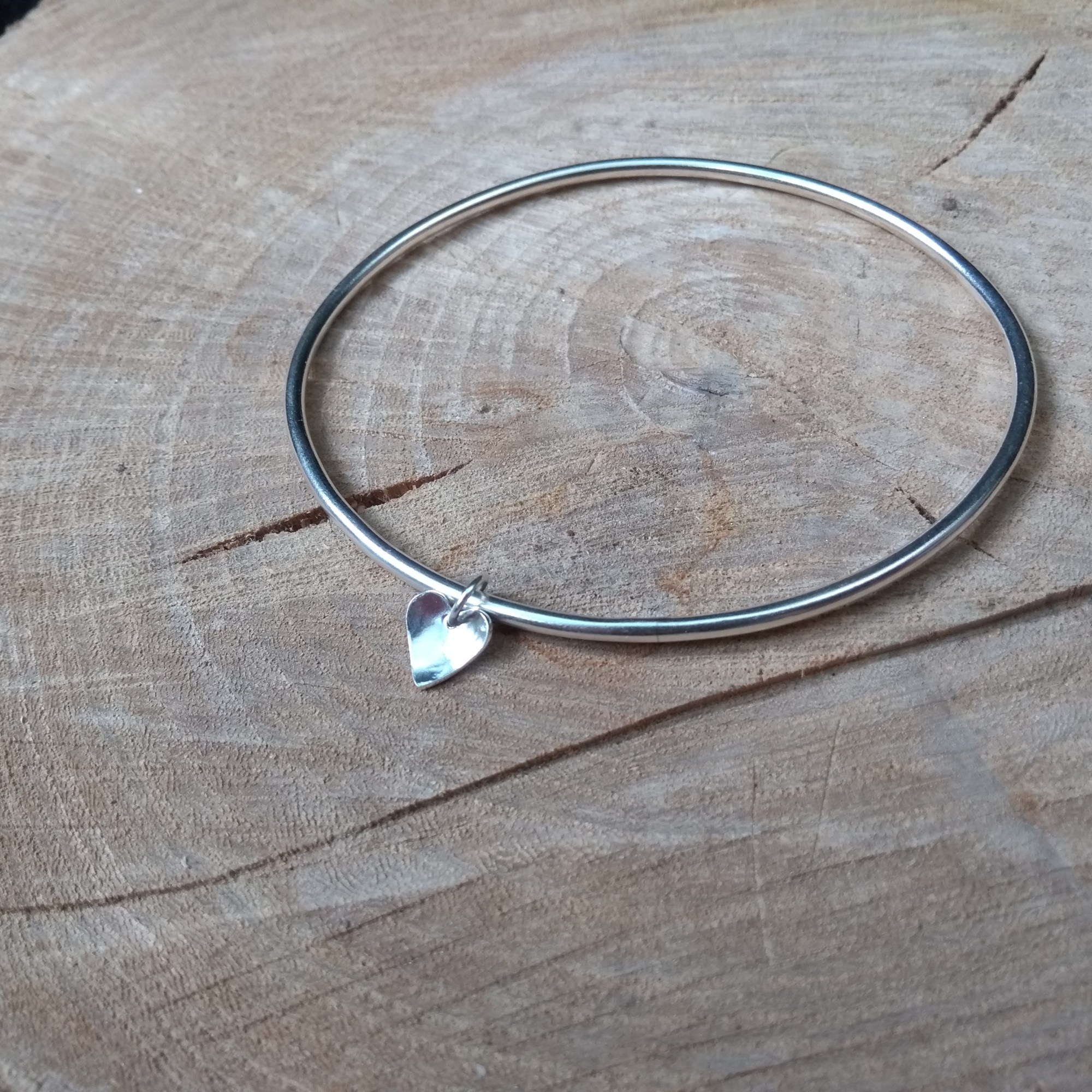 Silver bangle with heart dangle