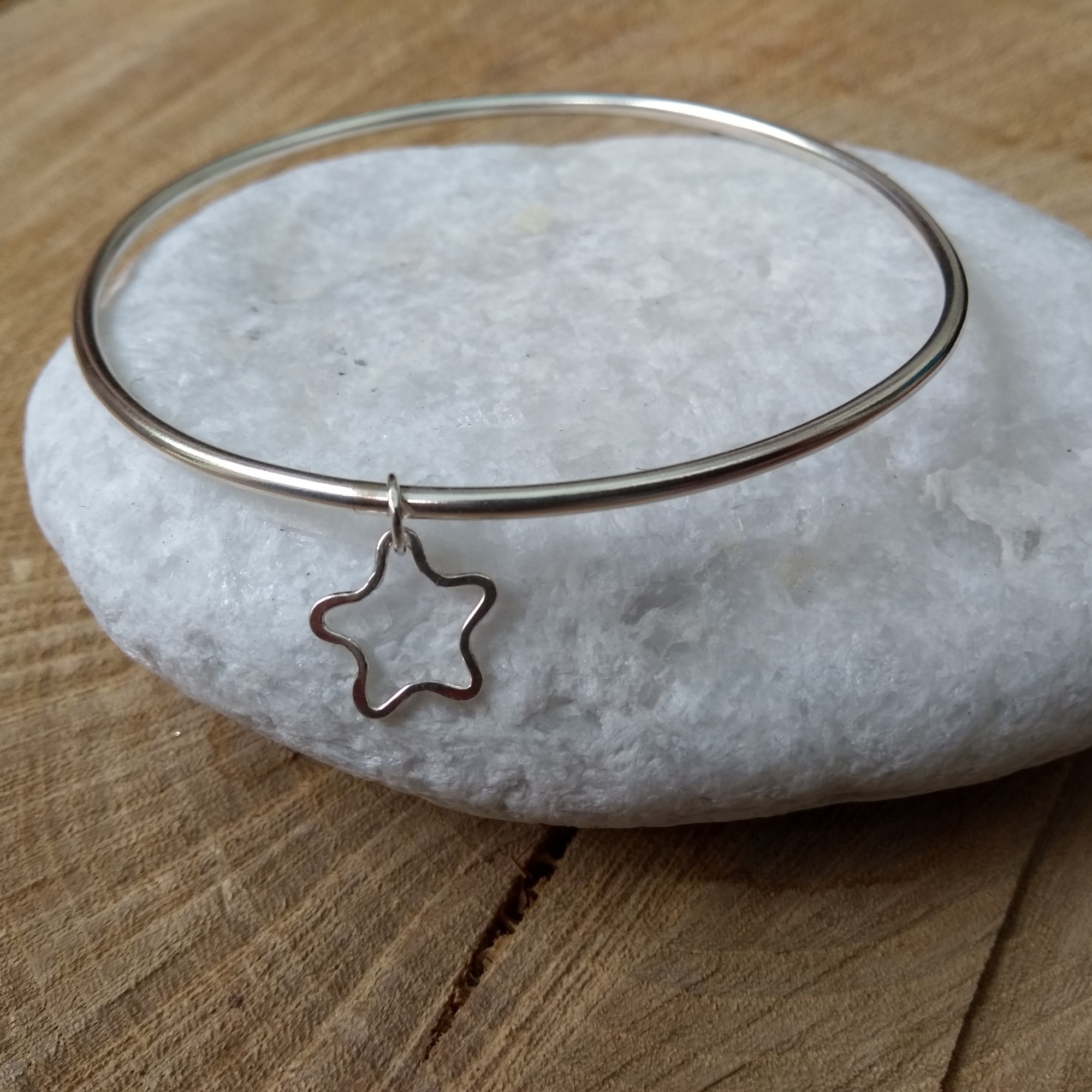 Silver bangle with star shaped dangle